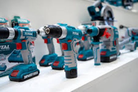 Power tools like drill machines, angle grinders, soldering irons, and welding machines plugged in and ready for use on a workbench